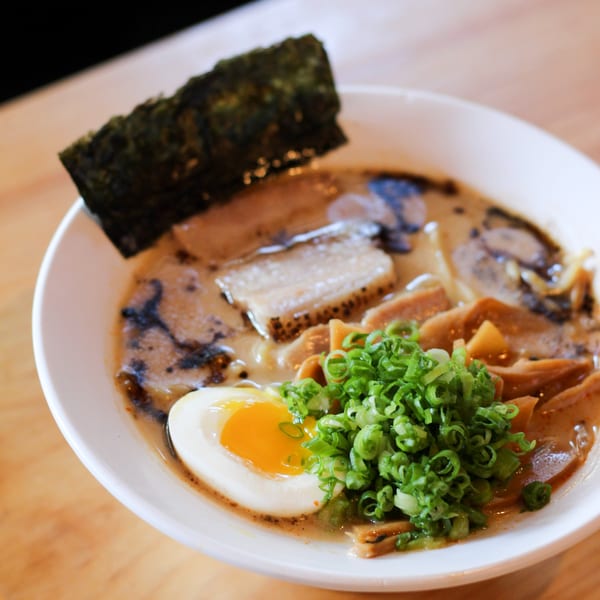 GoBistro ramen bowl with pork belly, soft-boiled egg, green onions, and nori.