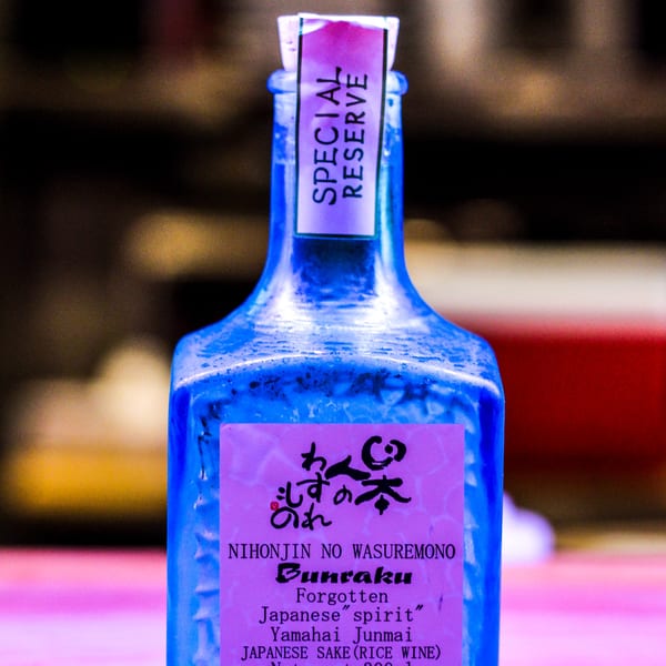 Close-up of a blue GoBistro sake bottle with a pink "Special Reserve" label.